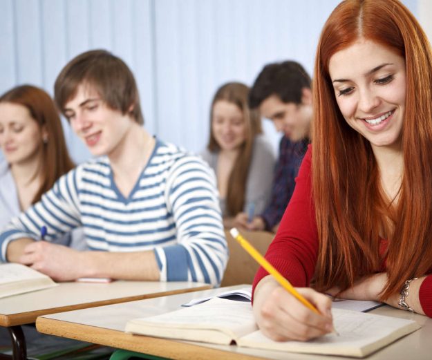 Group of students studying in classroom